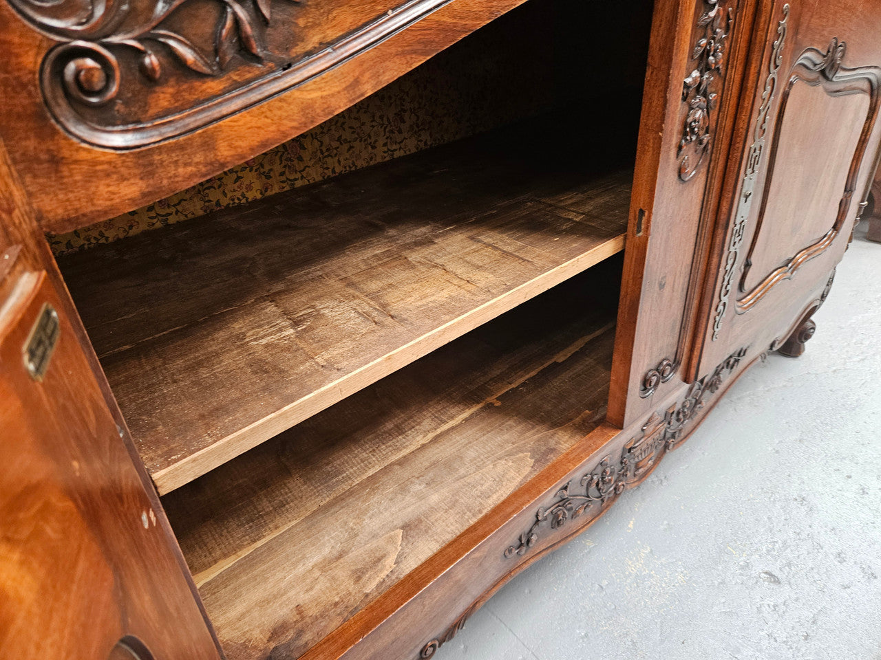 Attractive French Walnut Louis XV style two door two drawer sideboard featuring beautiful carving. Circa: 1930's. It has been sourced from France and it is in good original detailed condition.