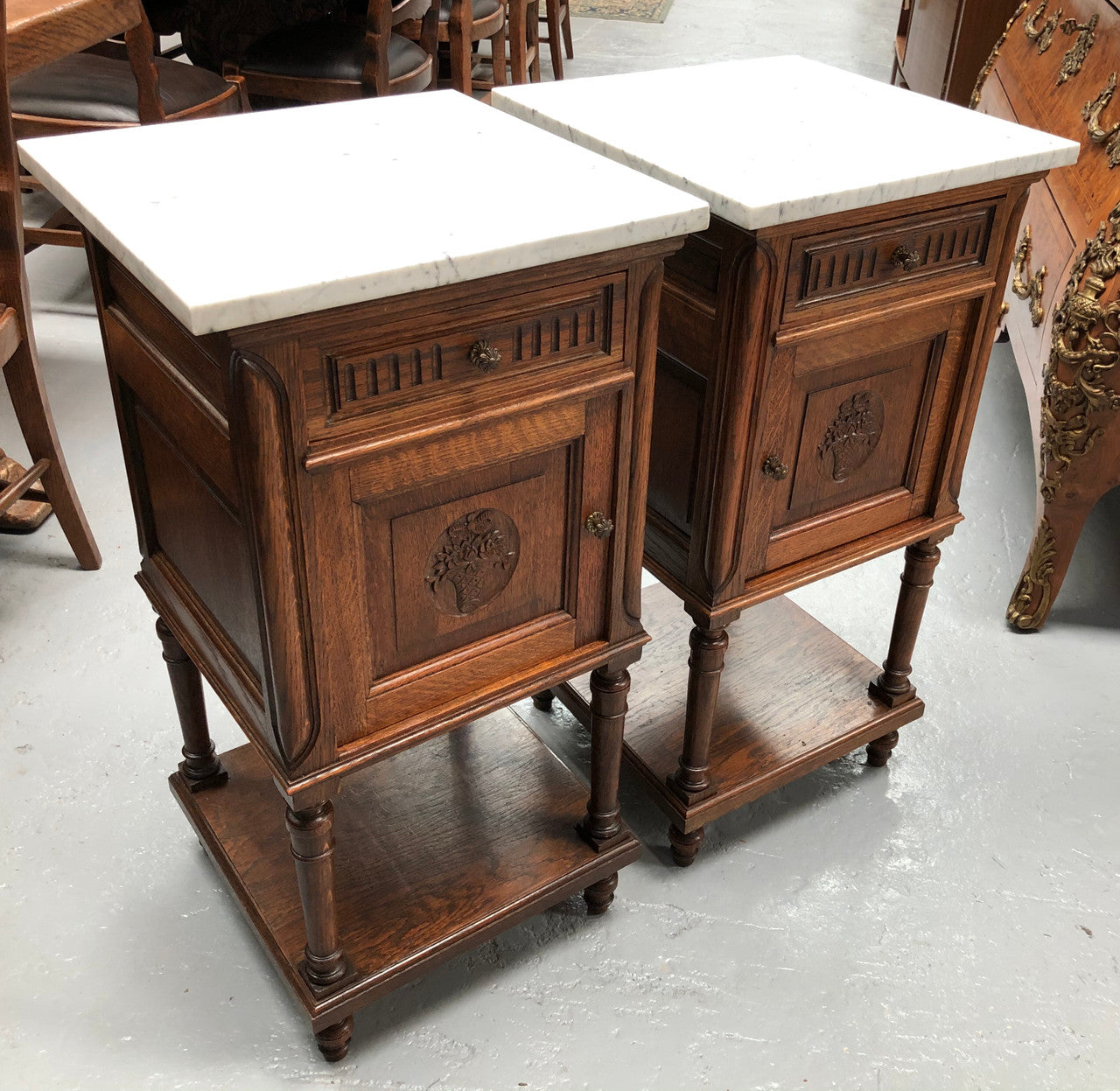 A french oak pair of carved bedside cabinets, with lovely detail and nice coloured marble tops and plenty of storage space. In good condition.