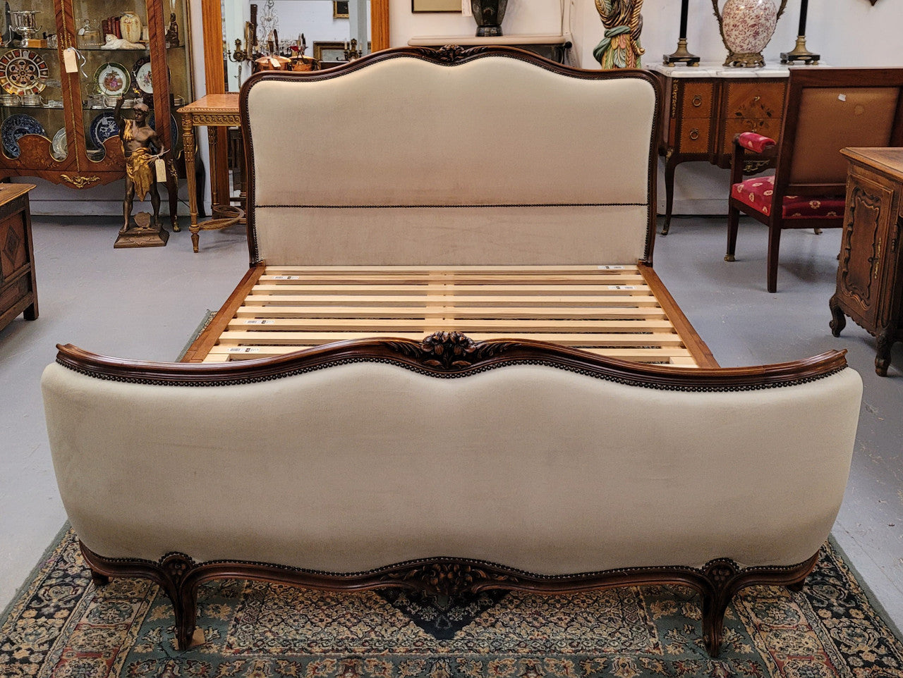 French Louis XV style queen size upholstered bed. Upholstery is in good condition and bed is complete with custom made slats. Just place your mattress on top.