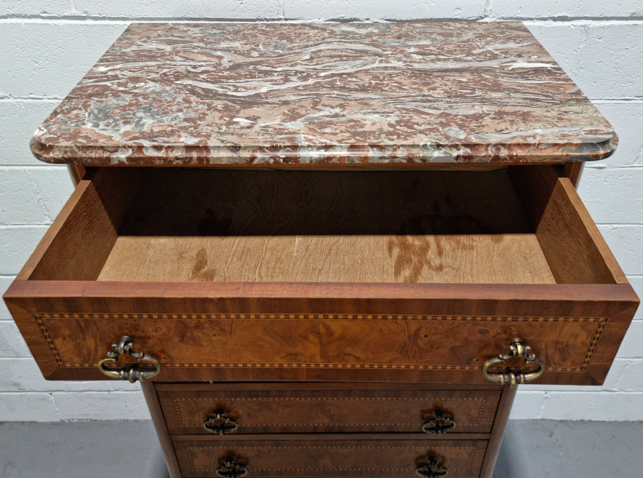 Louis XV style parquetry inlaid marble top semainier. It has seven drawers and a stunning coloured marble top. In good original condition.