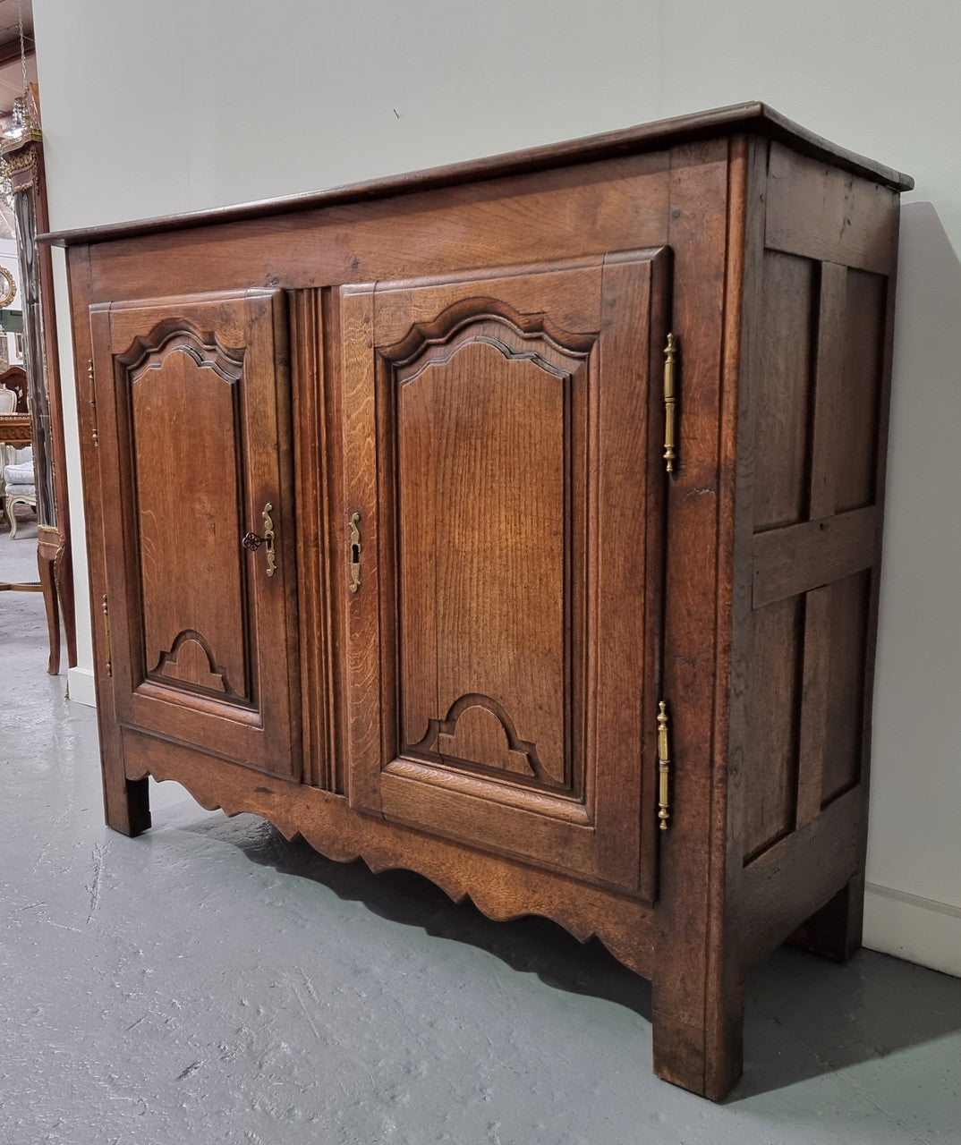 A charming French Oak early 18th Century two door sideboard. Plenty of storage space with two fixed shelves either side. It is in good original detailed condition for its age and comes with a working key and working locks.