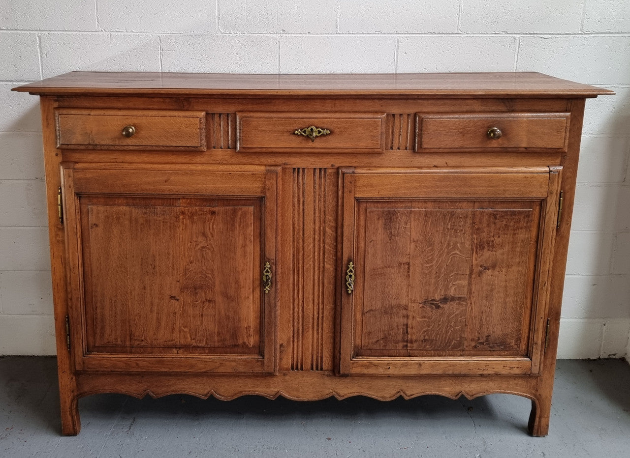 French Oak Early 19th Century sideboard with two doors and three drawers. In good original condition.