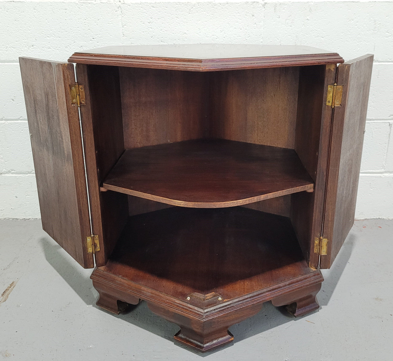 Hexagonal Mahogany enclosed side cabinet with two doors. Would make an ideal side cabinet and is in good restored condition.