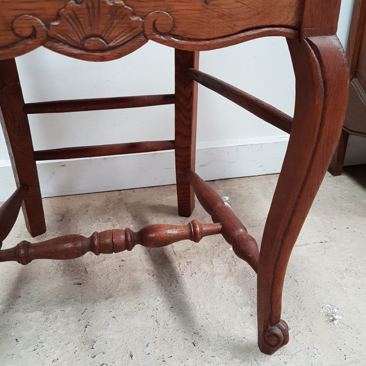 A set of six French Louis XV style, ladder back oak chairs. With finely carved detail and rush seat. In great original condition. Chairs are comfortable and sturdy for everyday use.