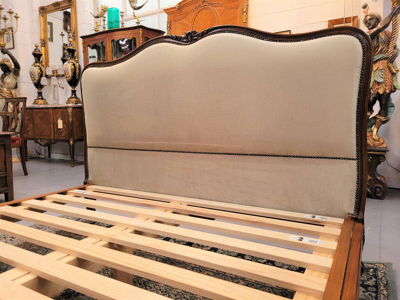French Louis XV style queen size upholstered bed. Upholstery is in good condition and bed is complete with custom made slats. Just place your mattress on top.