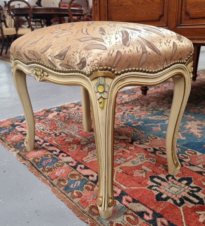 Appealing French Louis 15th style hand painted and gilded stool with good upholstery. In good original detailed condition.