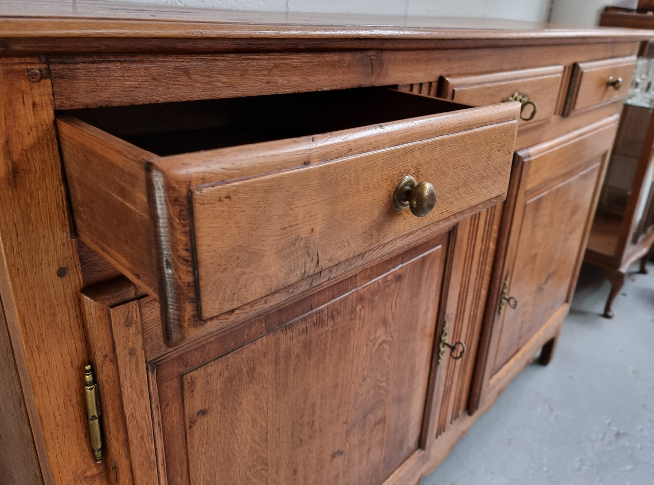 French Oak Early 19th Century sideboard with two doors and three drawers. In good original condition.