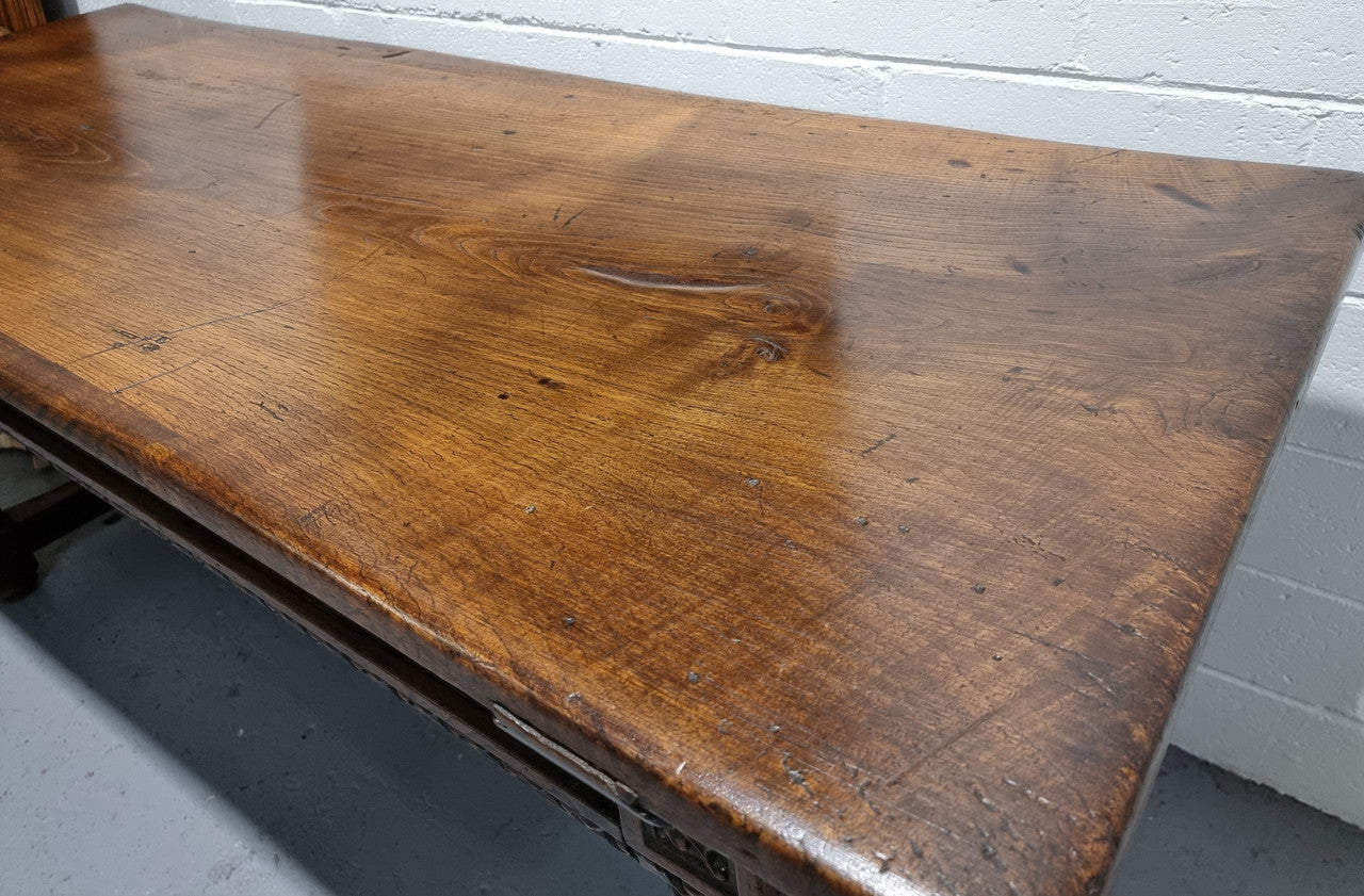 Rare and Charming 17th Century Spanish Walnut serving / side table. It has an incredible one piece walnut top with amazing character and colour. The base displays the original patina aswell as three drawers with carving and remnants of original locks. Superbly turned legs terminating on a stretcher base. Could be used as a large entrance console table, a side table or in a dining area as a serving table. In good original detailed condition especially considering its age.