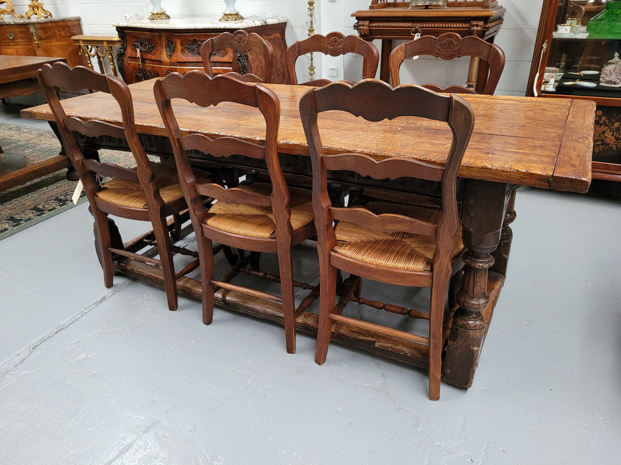 Set of six Louis XV style French Oak rush seat dining chairs. These chairs are very sturdy and have been professionally re-glued to ensure long lasting strength and sturdiness. They are in very good original detailed condition.