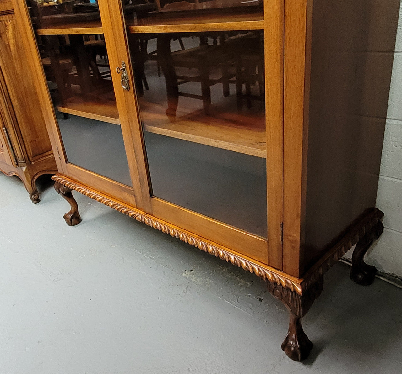 Chippendale style Mahogany two door bookcase. It has bevelled glass doors and two adjustable shelves. It has been sourced locally and is in good original detailed condition.