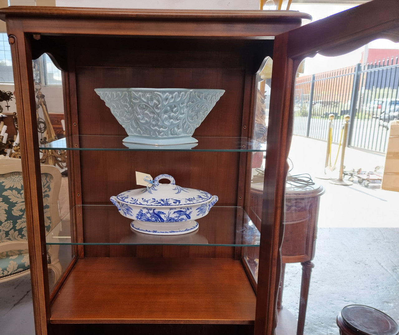 Petite French Louis XV style Walnut display cabinet with two glass shelves that can be adjusted and added storage at the bottom . In very good original detailed condition.