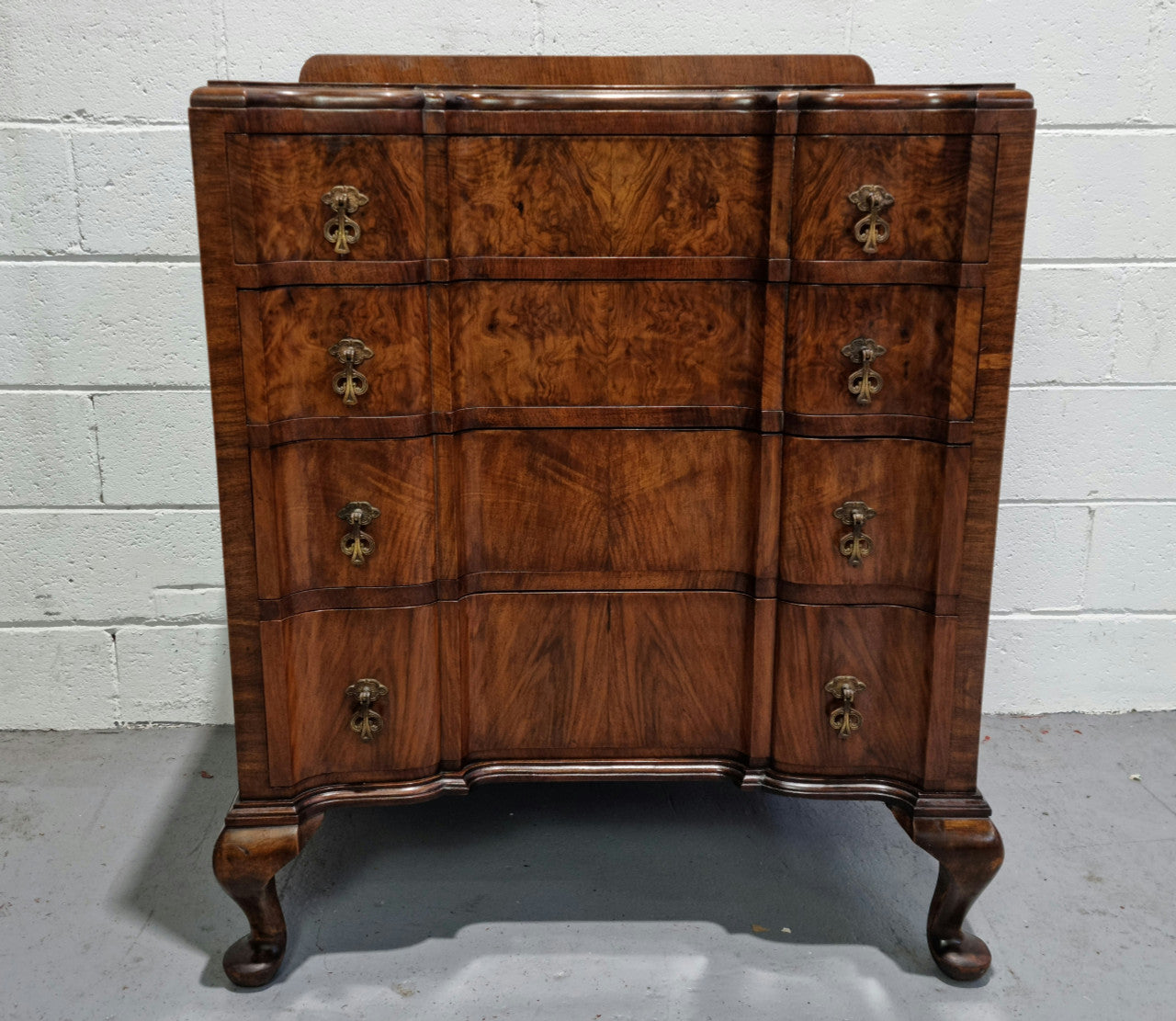 Antique English Figured Walnut inverted serpentine fronted chest of drawers. It is a great quality piece and is in good restored condition.