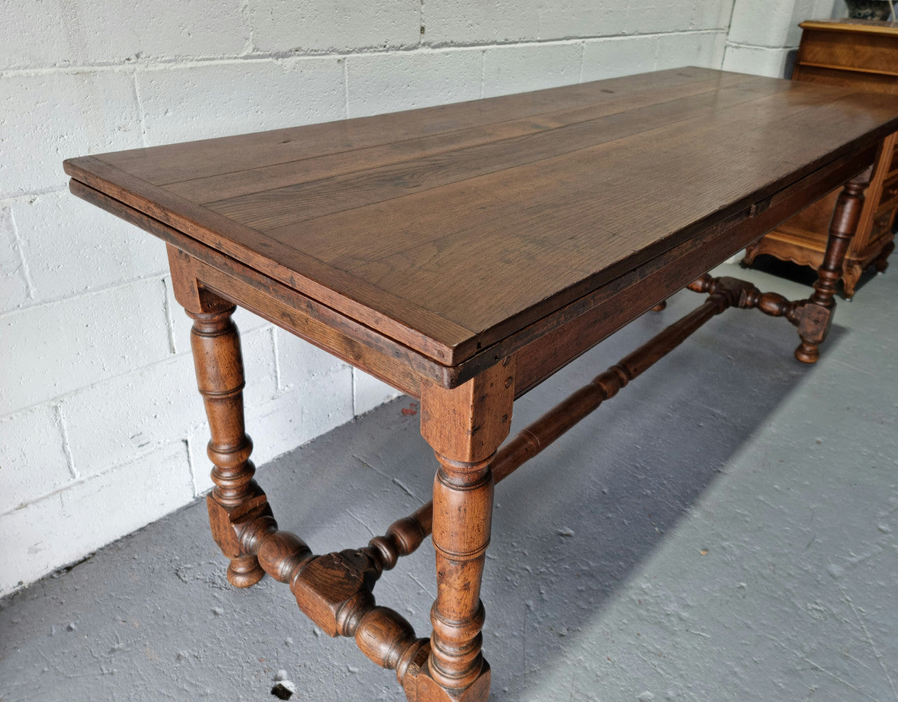 Appealing and rare French Oak Farmhouse extension table. Charming character to the top and comfortably seats 12 people. In good original detailed condition.