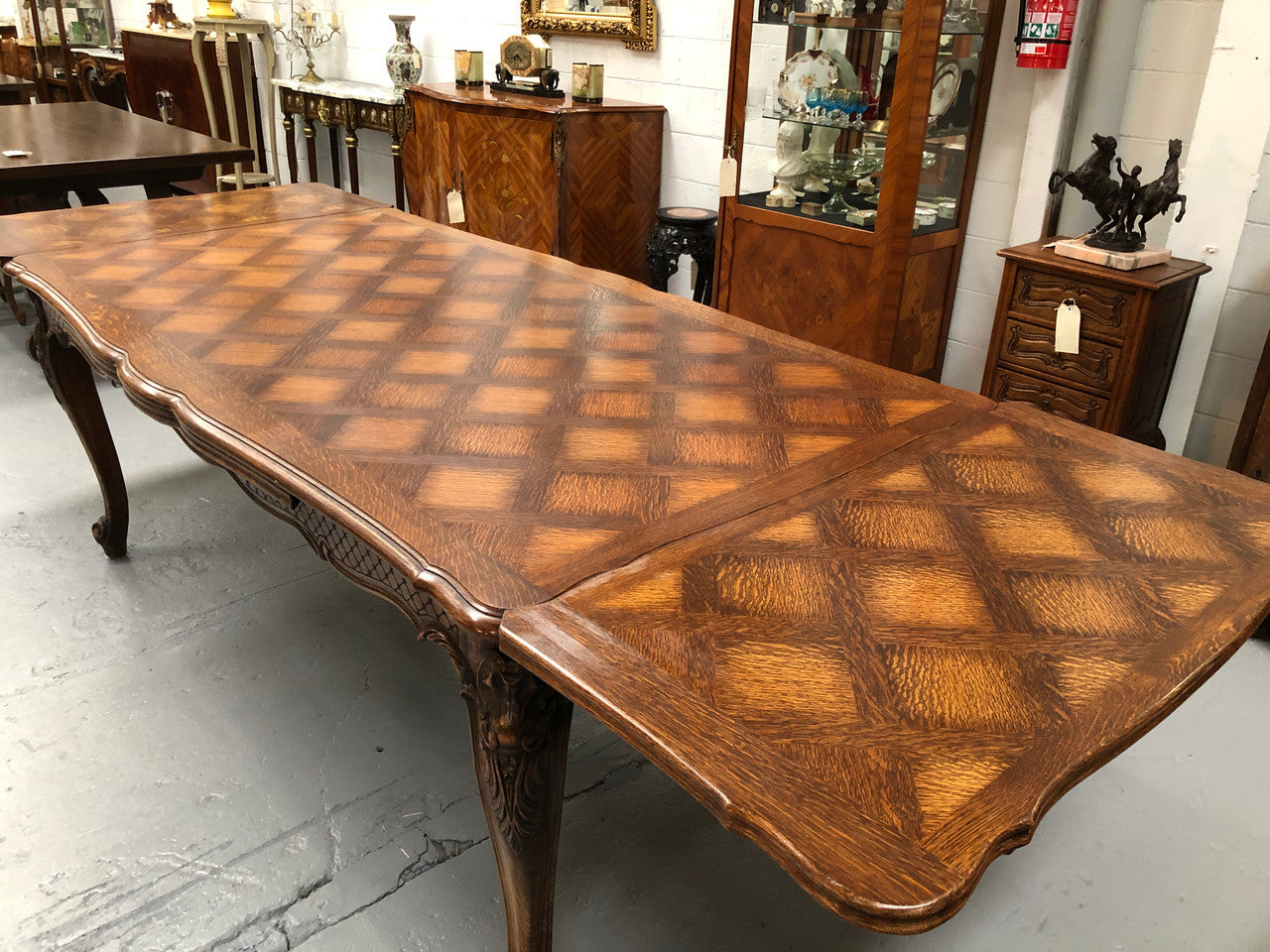 High quality French Oak Louis XV Style, beautifully carved extension table. It has an amazing parquetry top and when fully extended measures to 3 meters long. In very good original detailed condition.