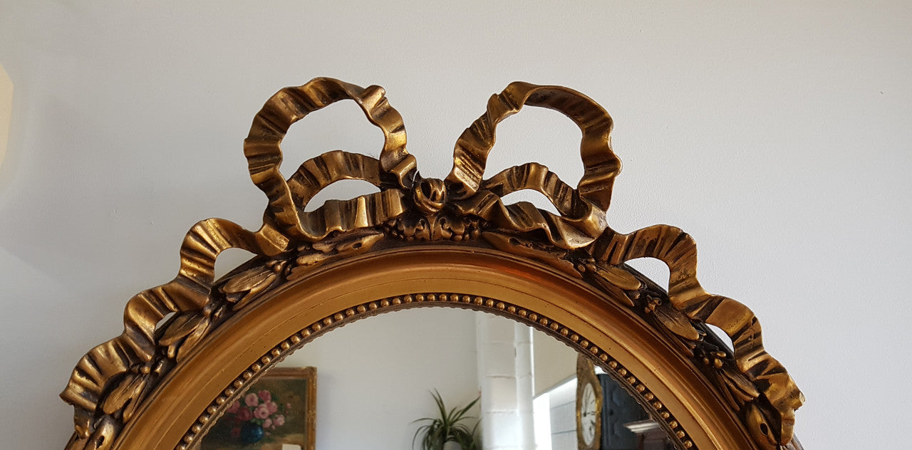 Antique French Gilt Oval Shape Mirror With Ribbon Crest