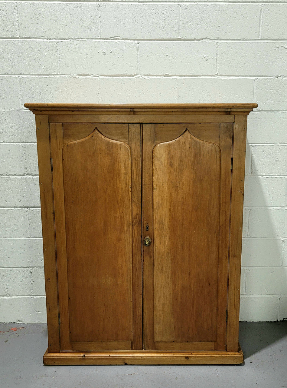 A lovely Victorian Pine shield cupboard with two doors and four shelves in good original detailed condition.