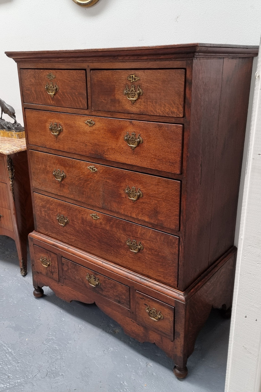 Early 19th Century English Oak chest on stand. It has been sourced in France and has plenty of storage space with eight drawers. In good original detailed condition.