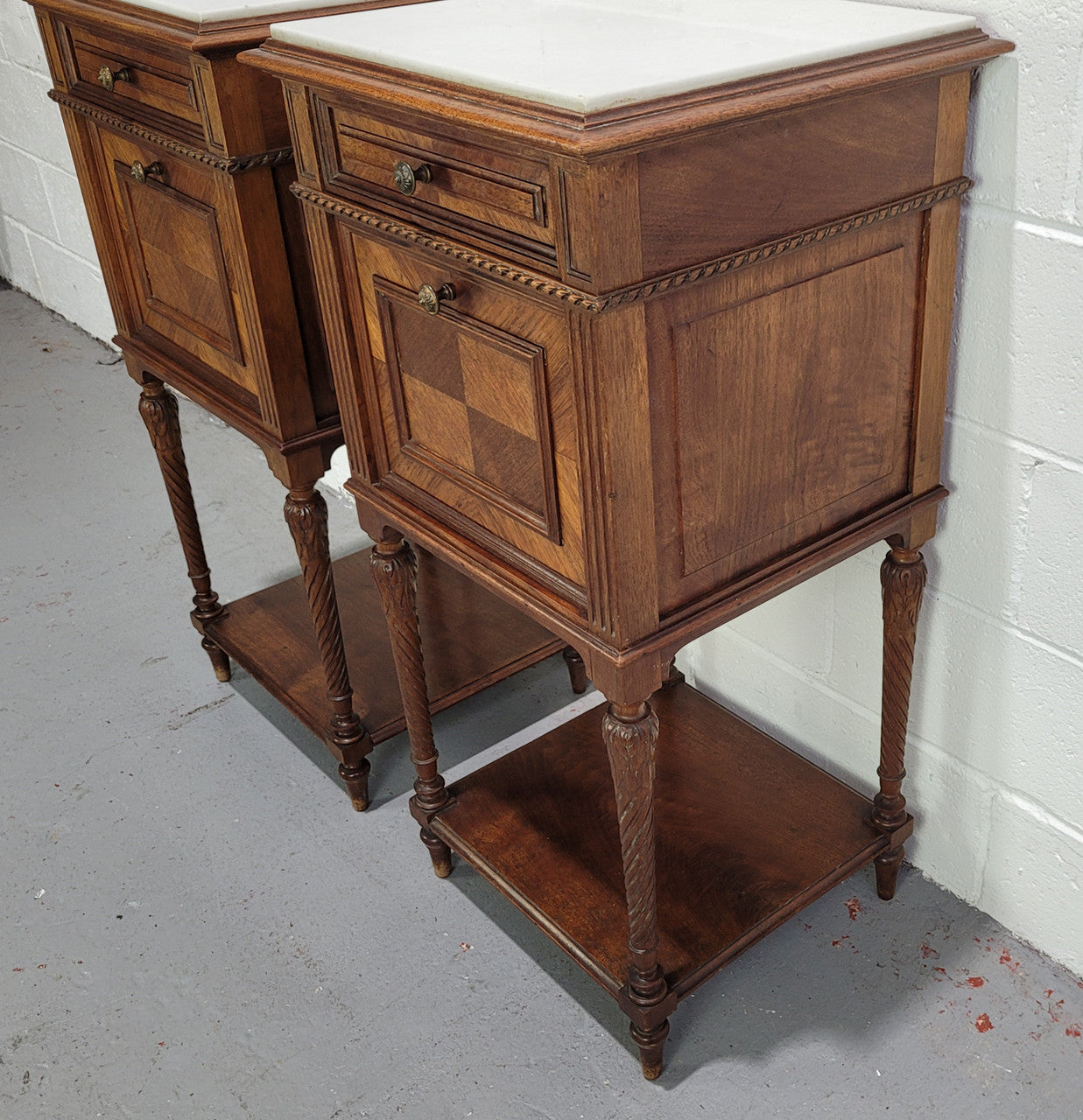 Pair parquetry Walnut bedside cabinets with white inset marble tops. In good original detailed condition.