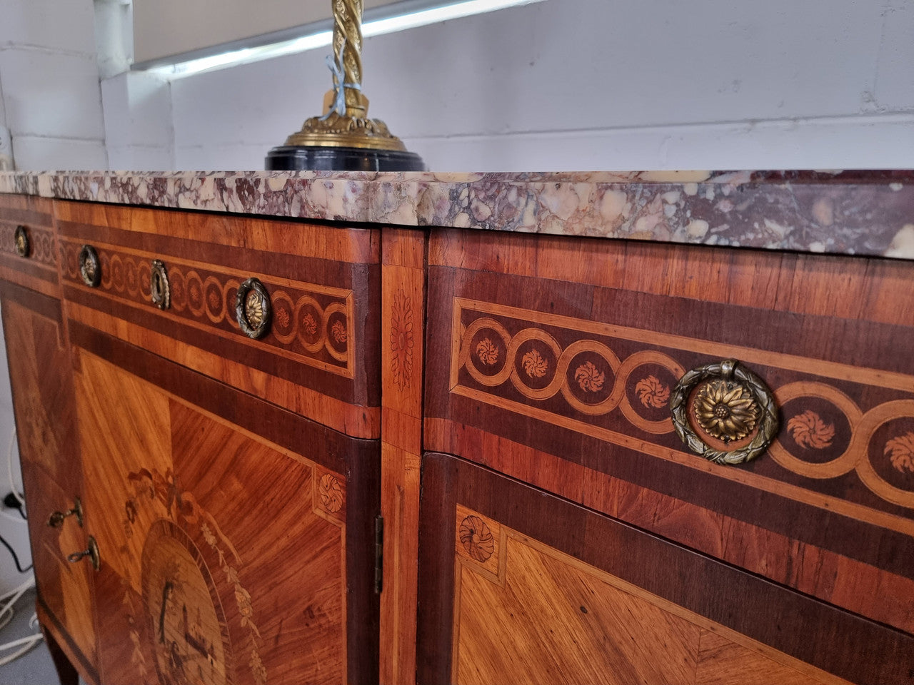 A high quality 19th Century French marquetry inlaid Kingwood marble top credenza. It has an attractive solid marble top and decorative marquetry inlay throughout. It has plenty of storage space with three drawers and three doors. It has been sourced from France and is in good original detailed condition.