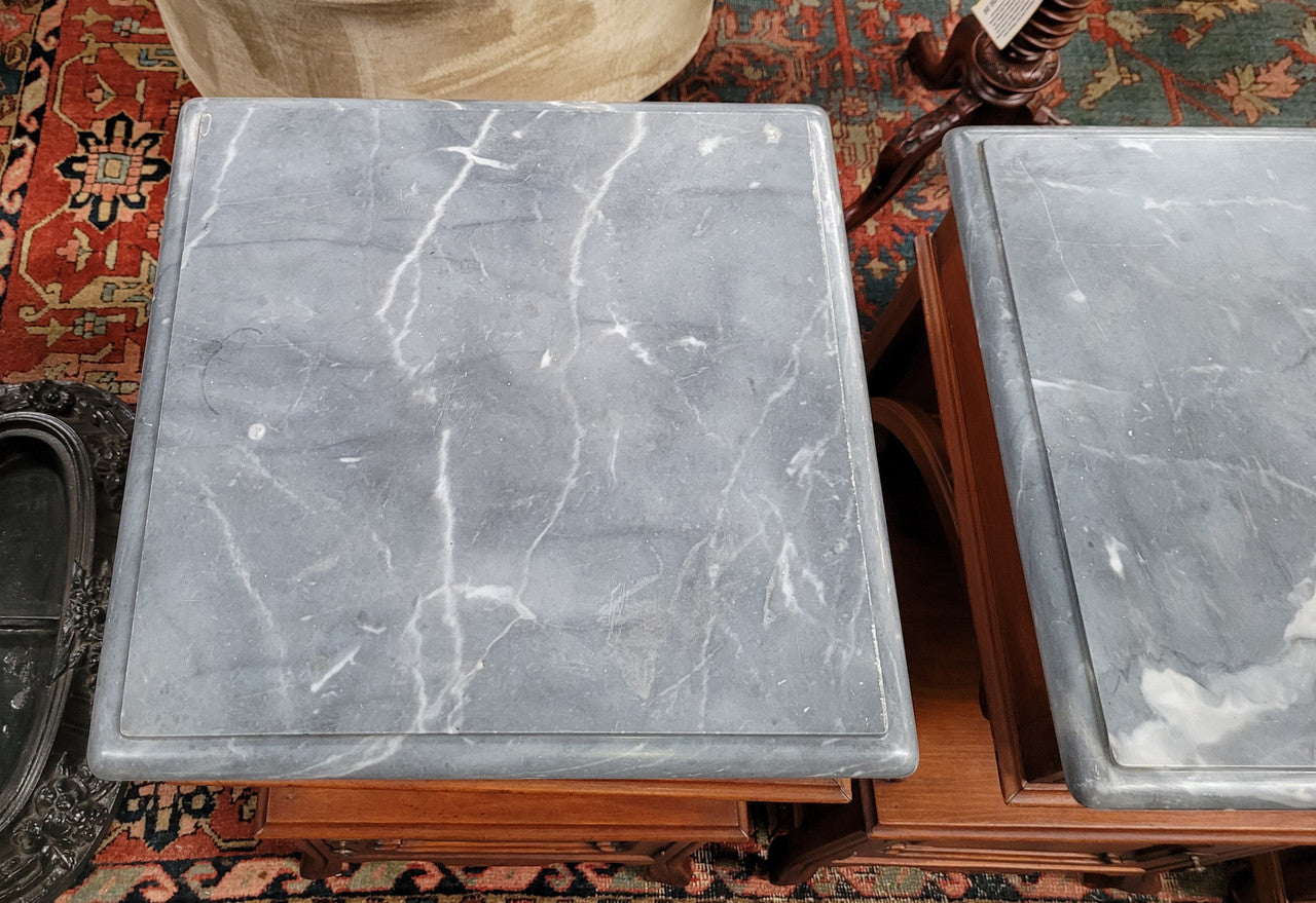 Pair of unusual transitional fruit wood marble top bedside cabinets. They have been sourced from France and are in good original detailed condition.