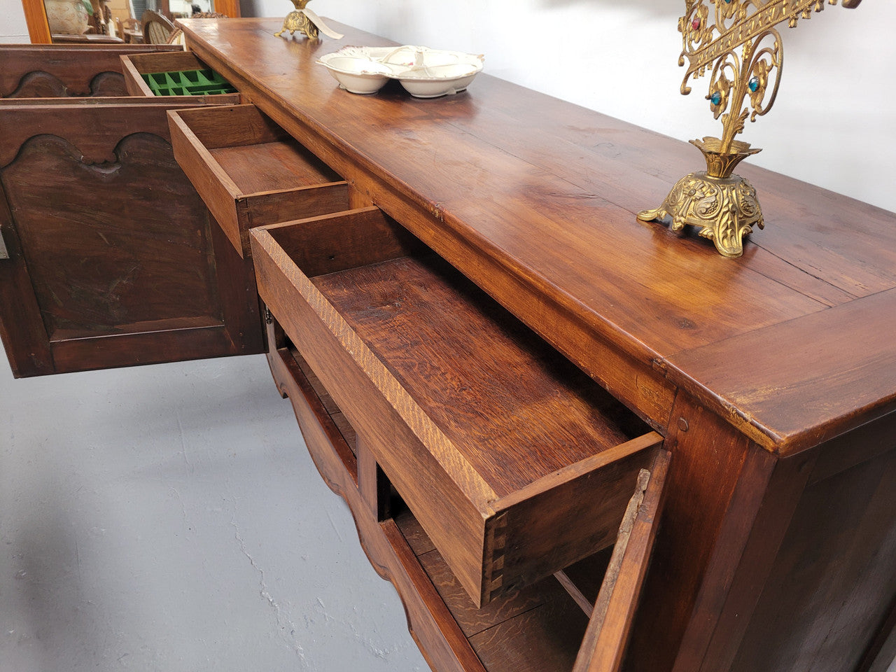 Early 19th Century Louis XV style Fruitwood three door sideboard. It has three hidden internal drawers and one of them has green valet and small sections for cutlery. It is in good restored condition.