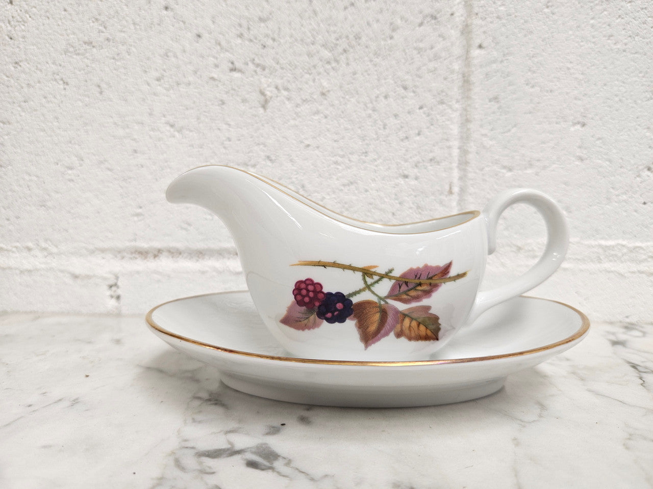 Royal Worcester "Evesham" Pattern small Jug and Saucer. Good Condition no cracks or chips. Please see photos as they form part of the description.