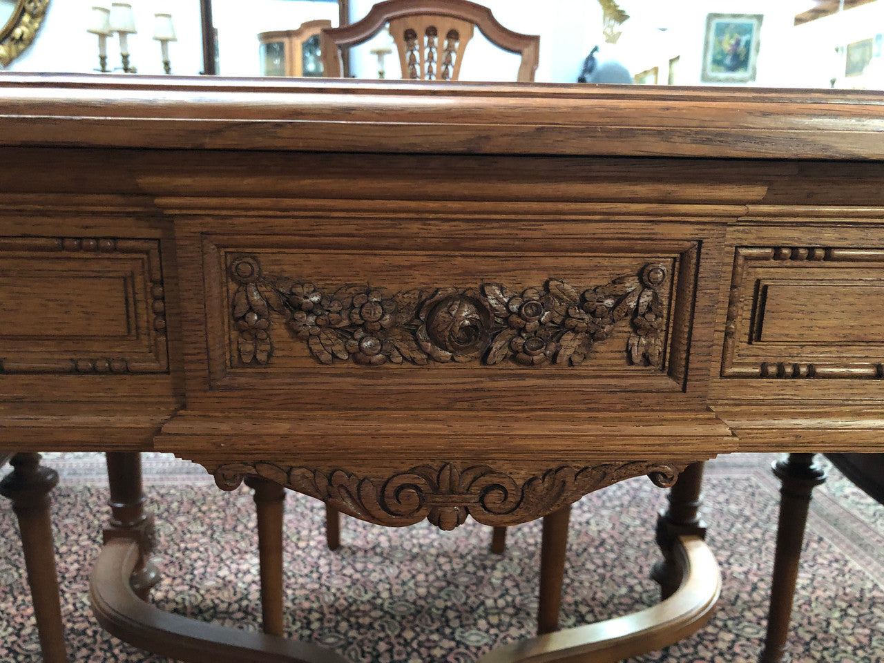 Lovely carved French Oak dining table with a parquetry top and six matching upholstered chairs in good original detailed condition.