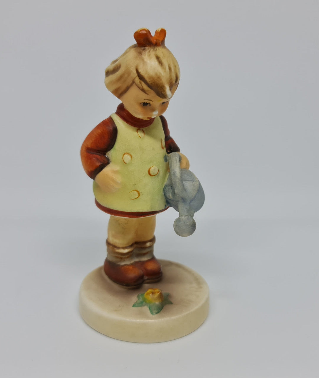 Gorgeous Hummel girl with watering can figurine, marked #74 . In great original condition.