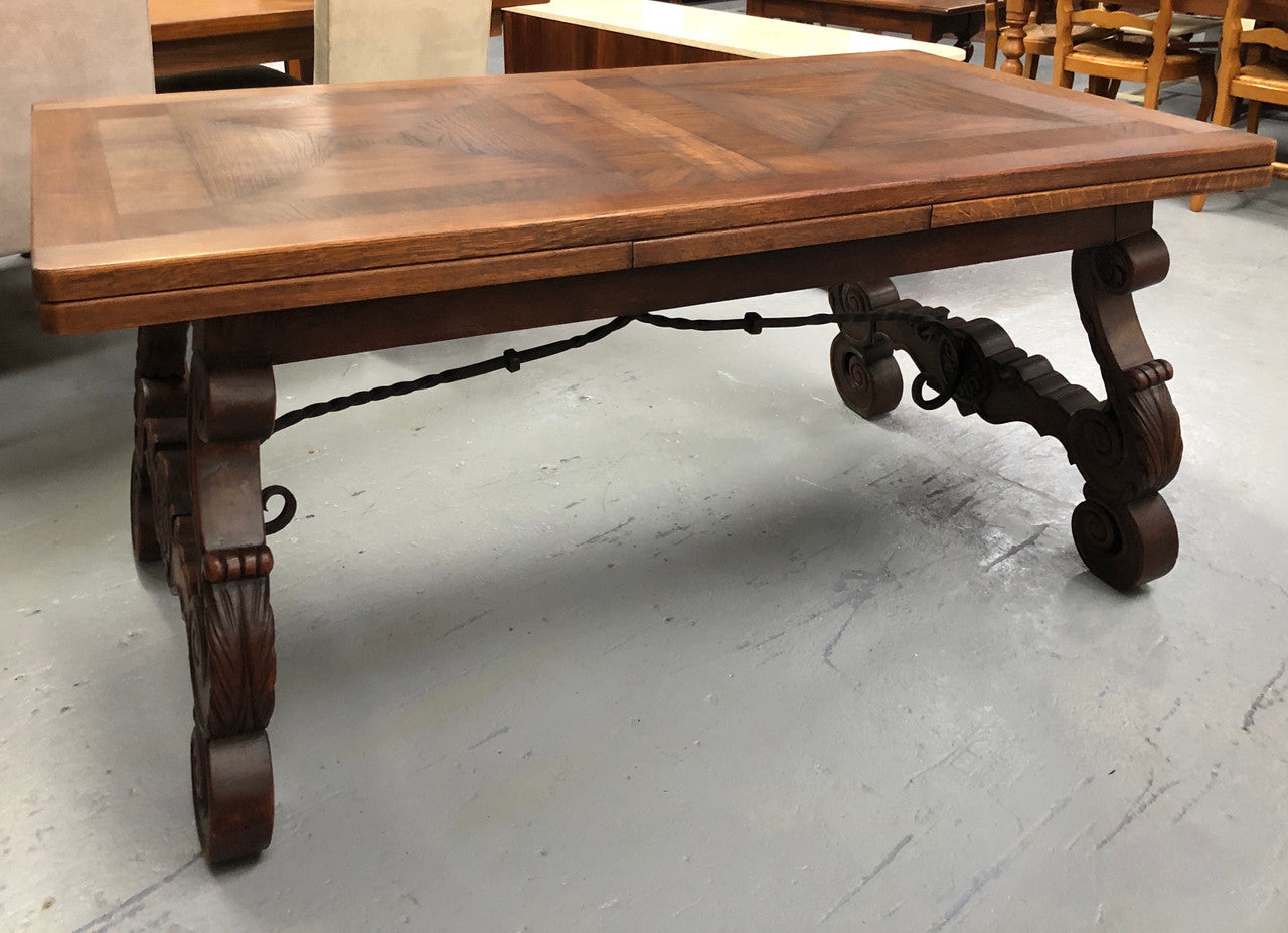 French Oak Renaissance style extension table with a lovely parquetry top and decorative carved and iron base in good original detailed condition.