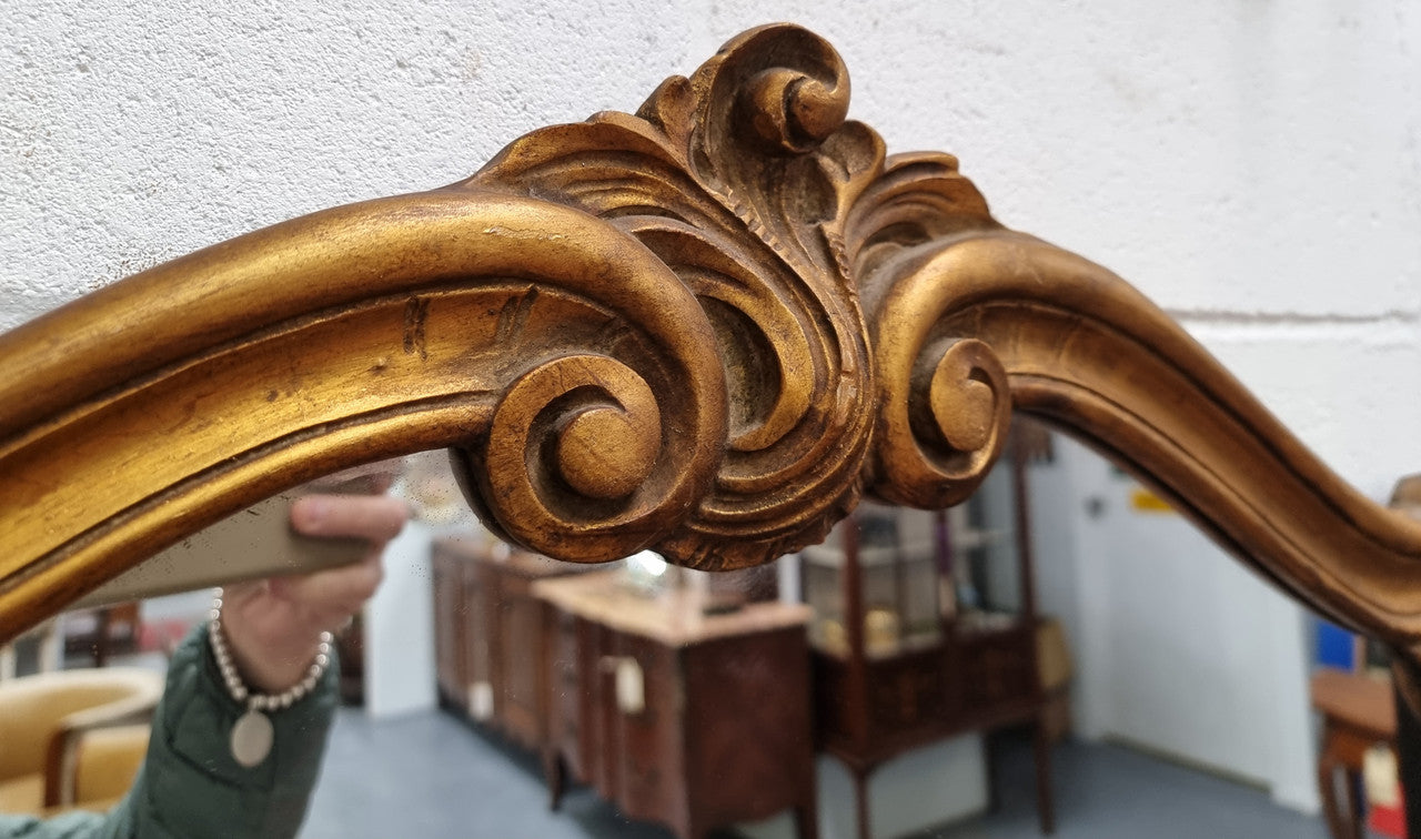 French Louis XV style wood carved and gilded mirror. Mirror is original and showing signs of age. It has been sourced from France and in good original condition.