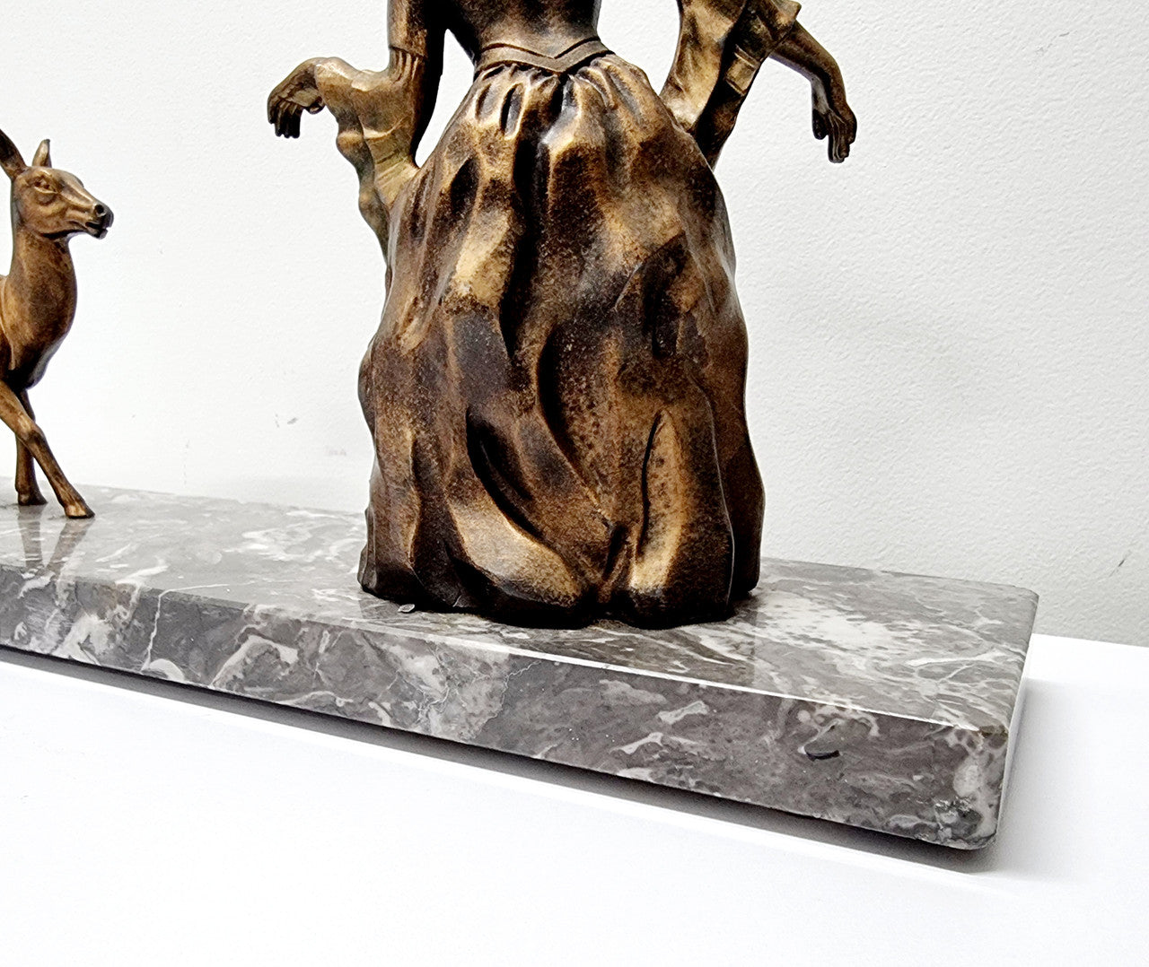 Art Deco gilt metal lady and deer statue on a lovely grey marble base. It has been sourced from France and is in good original condition. The marble does have some minor chips and wear due to age, please view photos as they help form part of the description. Please contact us if you would like additional photos.