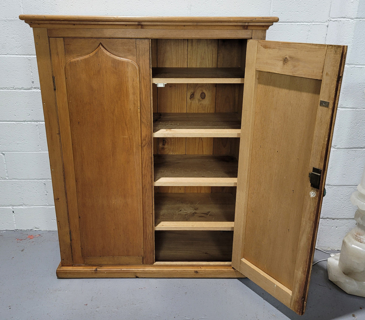 A lovely Victorian Pine shield cupboard with two doors and four shelves in good original detailed condition.