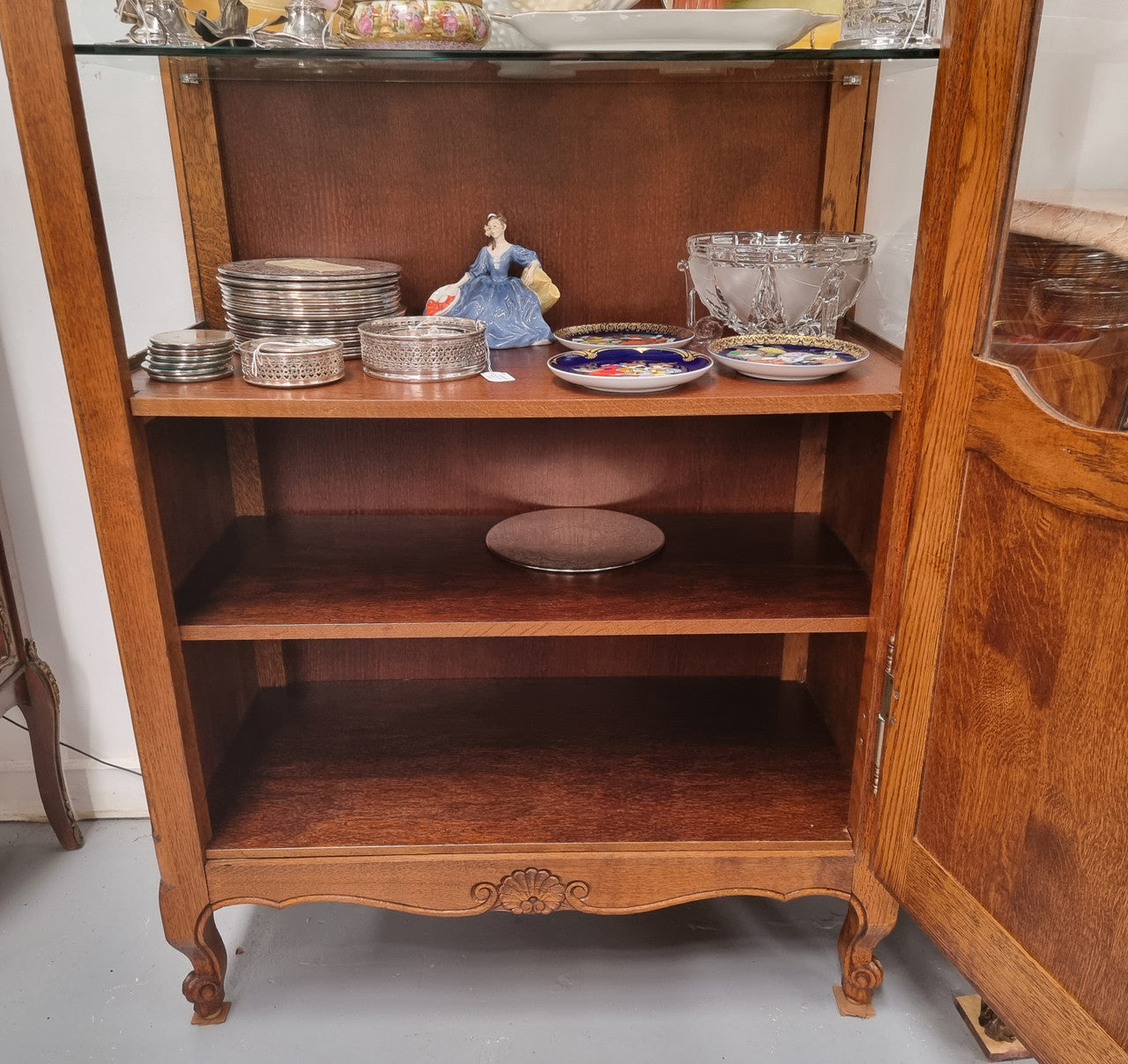 French Oak Louis XV Style Vitrine with two fixed glass shelves at the top and two fixed wooden shelves at the base for added storage. It has been sourced from France and in good original detailed condition.