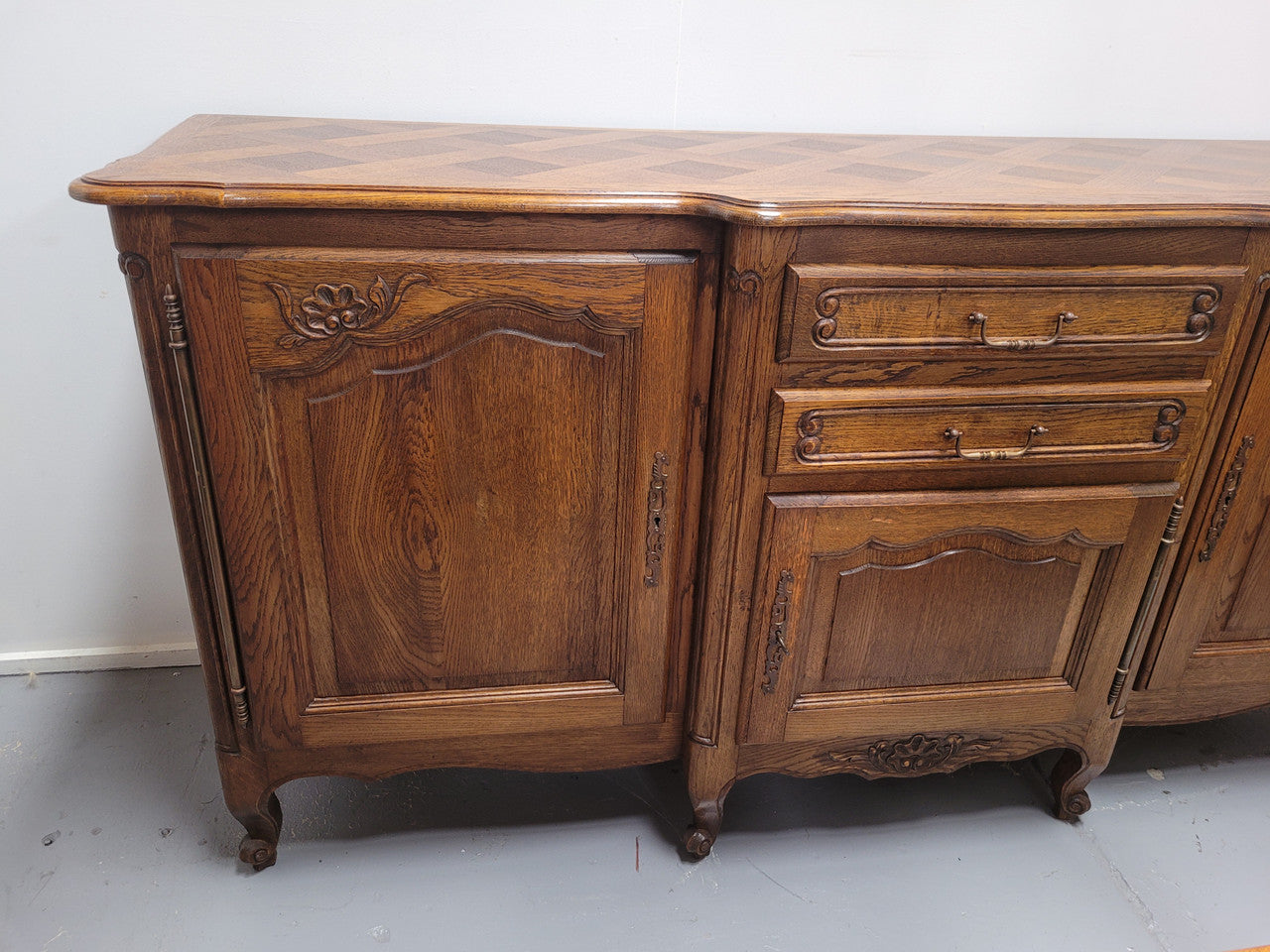 French Oak Louis XV style three door, two drawer, parquetry top sideboard. It has been sourced from France and is in good restored condition.