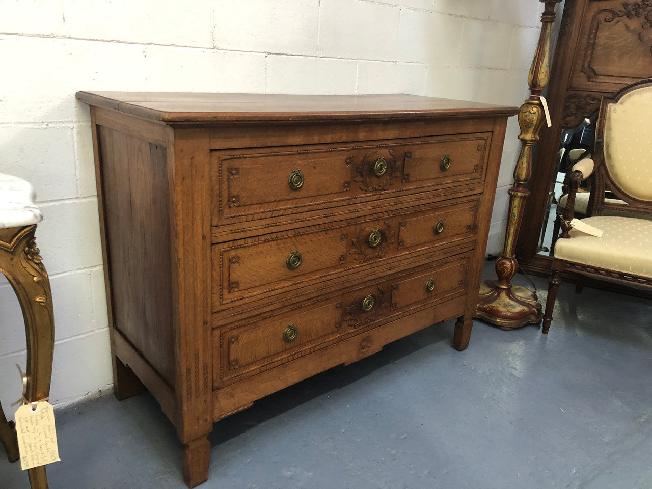 Lovely carved early 19th Century French Oak commode. There are three drawers with decorative drawer pulls and is in good original detailed condition.