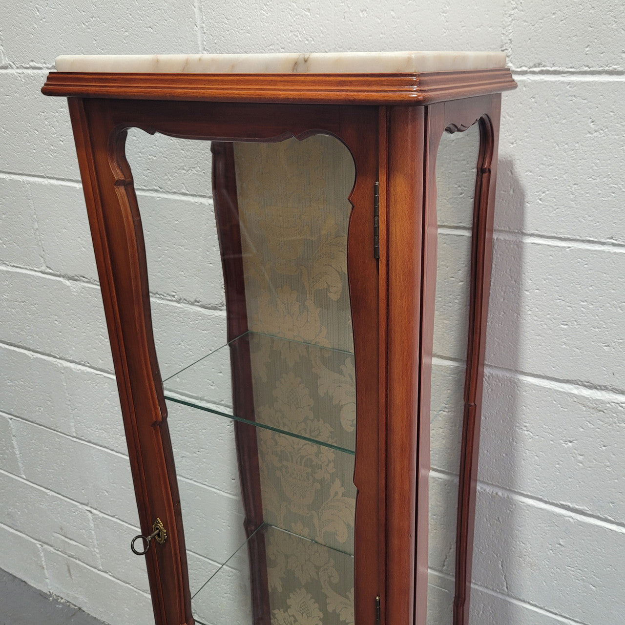 French Louis XV style small scaled display cabinet with marble top. It is of pleasing proportions with a lovely olive french damask fabric back and two glass shelves. In good original detailed condition.