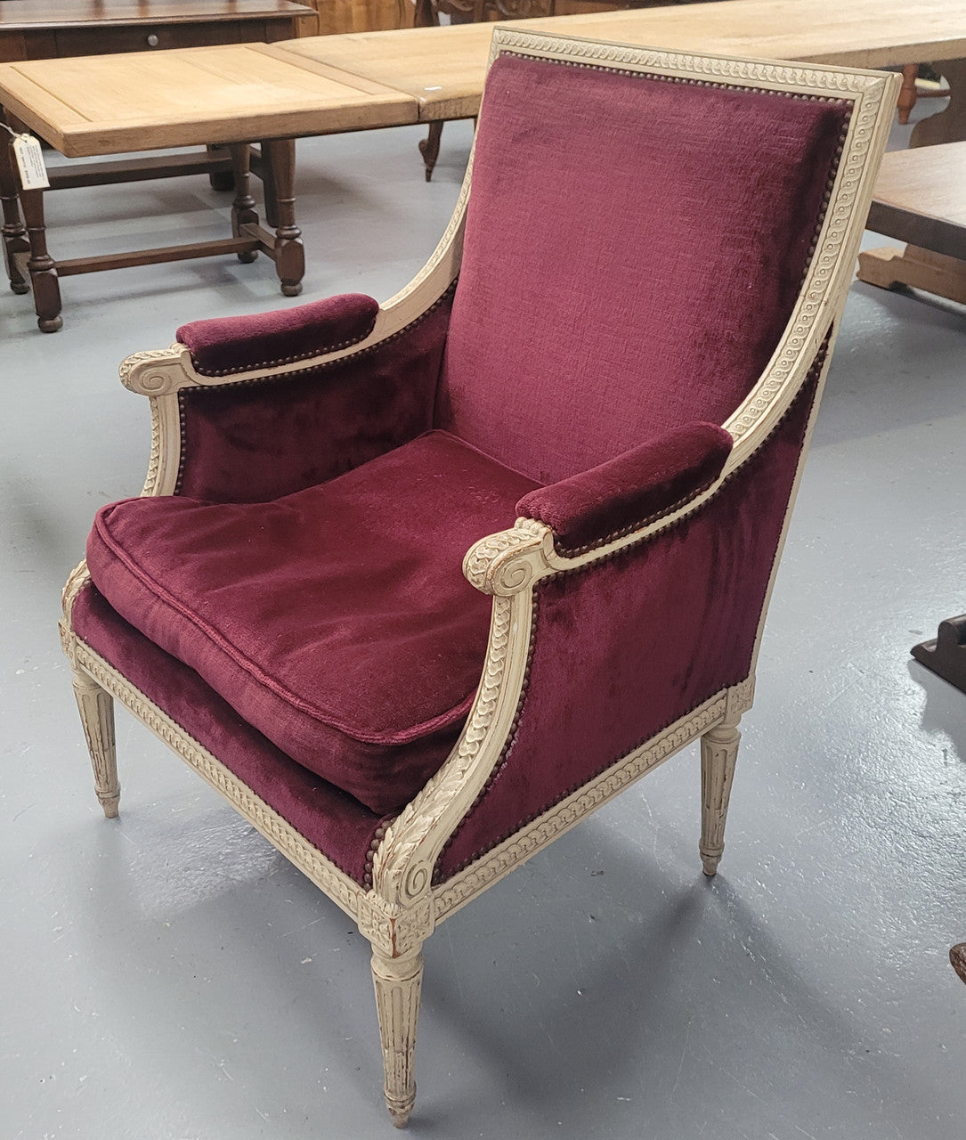 Louis 16th Style high back upholstered chair with maroon velvet fabric, decorative carvings and original paint. It has been sourced from France and in good original condition.