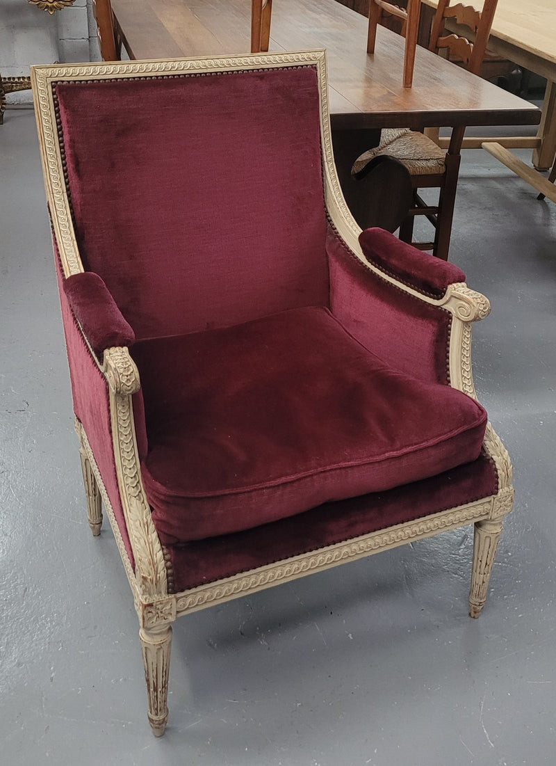 Louis 16th Style high back upholstered chair with maroon velvet fabric, decorative carvings and original paint. It has been sourced from France and in good original condition.