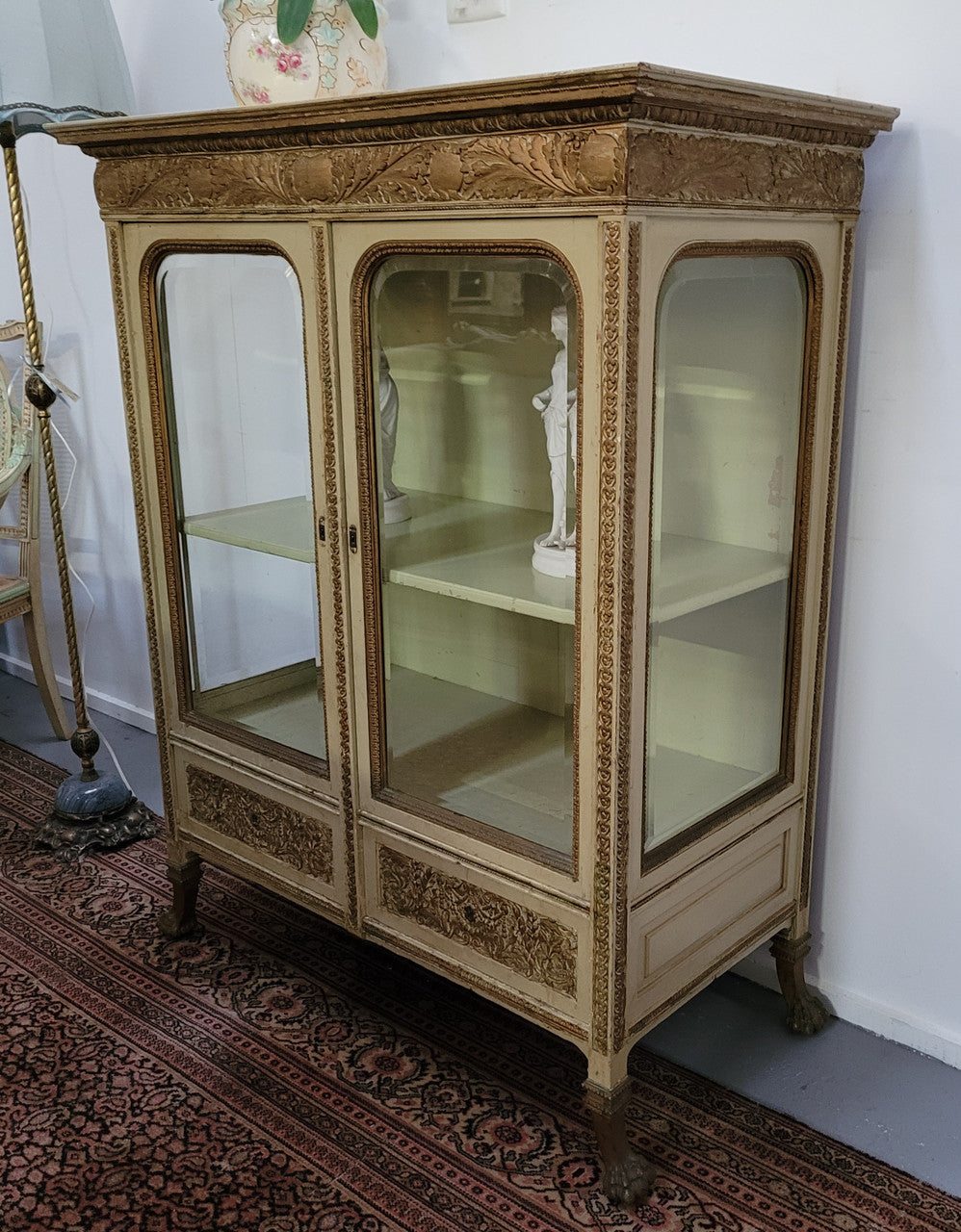19th Century painted and gilt two door vitrine. Has one adjustable shelf and two drawers. In good original detailed condition.