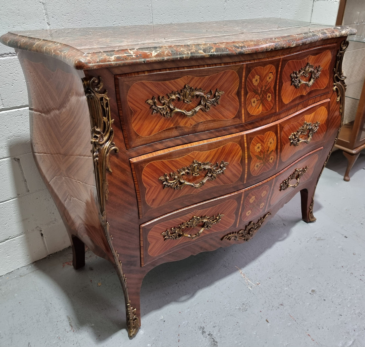French Walnut and Kingwood Louis XV style marquetry inlaid commode with three drawers and a beautiful marble top. It is in good original detailed condition.