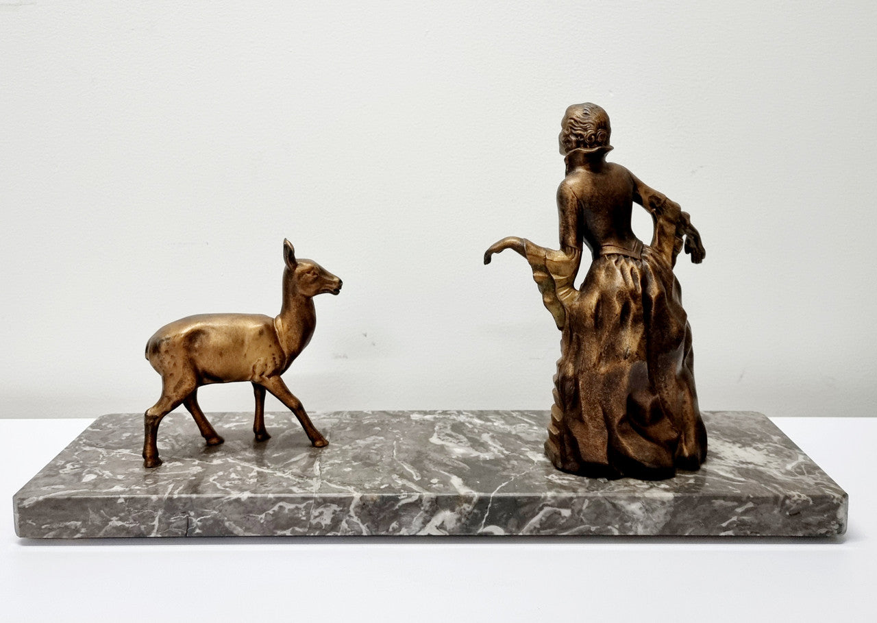 Art Deco gilt metal lady and deer statue on a lovely grey marble base. It has been sourced from France and is in good original condition. The marble does have some minor chips and wear due to age, please view photos as they help form part of the description. Please contact us if you would like additional photos.