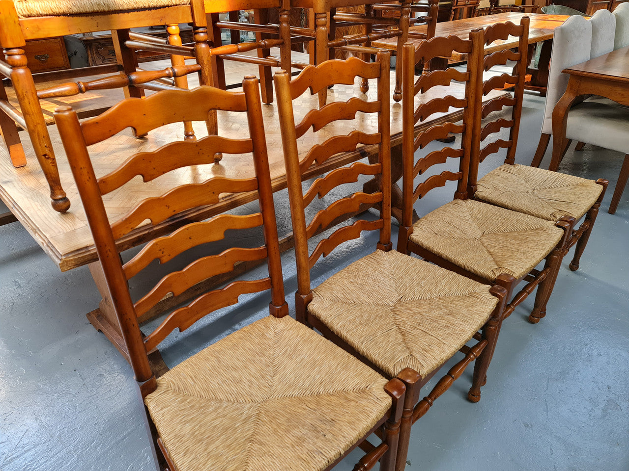 Charming set of eight Cherry Wood ladder back dining chairs. They are in good original detailed condition.