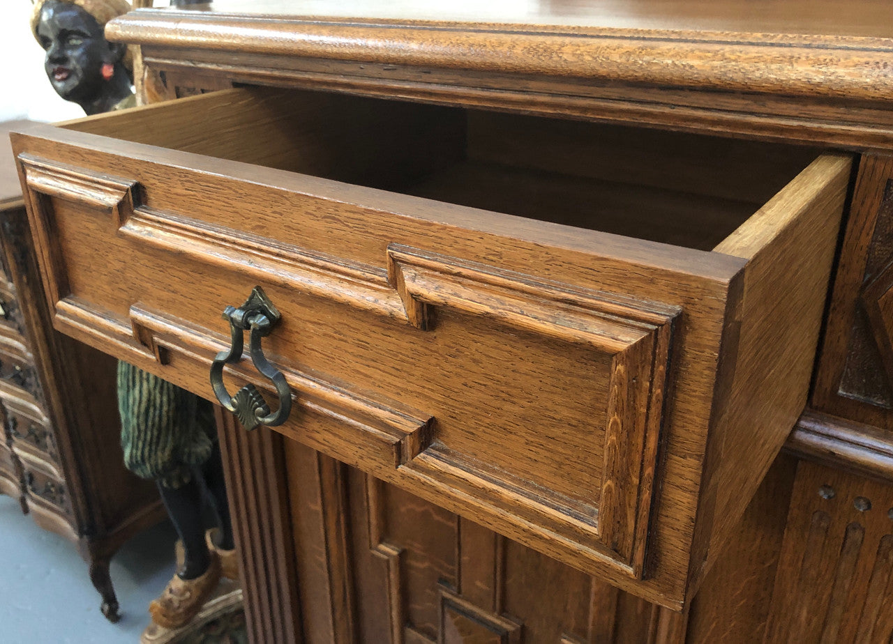 Beautiful carved French Oak four-door buffet with three drawers and lots of room for storage in good original detailed condition.