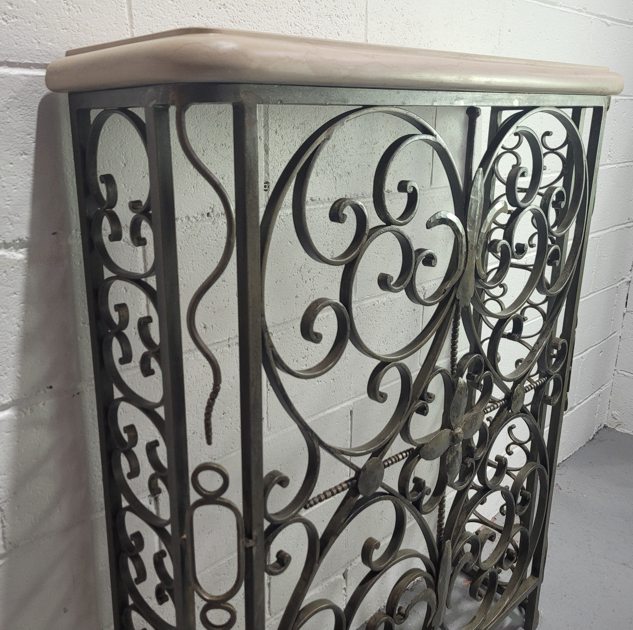 Stunning Art Deco wrought iron and marble top console table. It has amazing decorative iron work at the bottom and a beautiful marble top. It is in good original detailed condition.