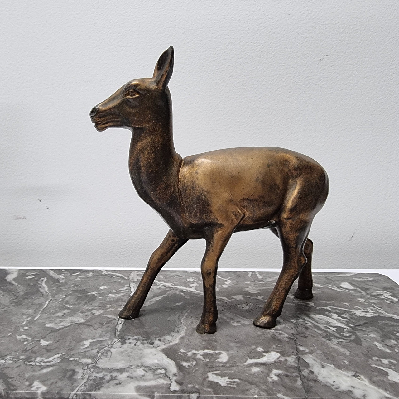 Art Deco gilt metal lady and deer statue on a lovely grey marble base. It has been sourced from France and is in good original condition. The marble does have some minor chips and wear due to age, please view photos as they help form part of the description. Please contact us if you would like additional photos.