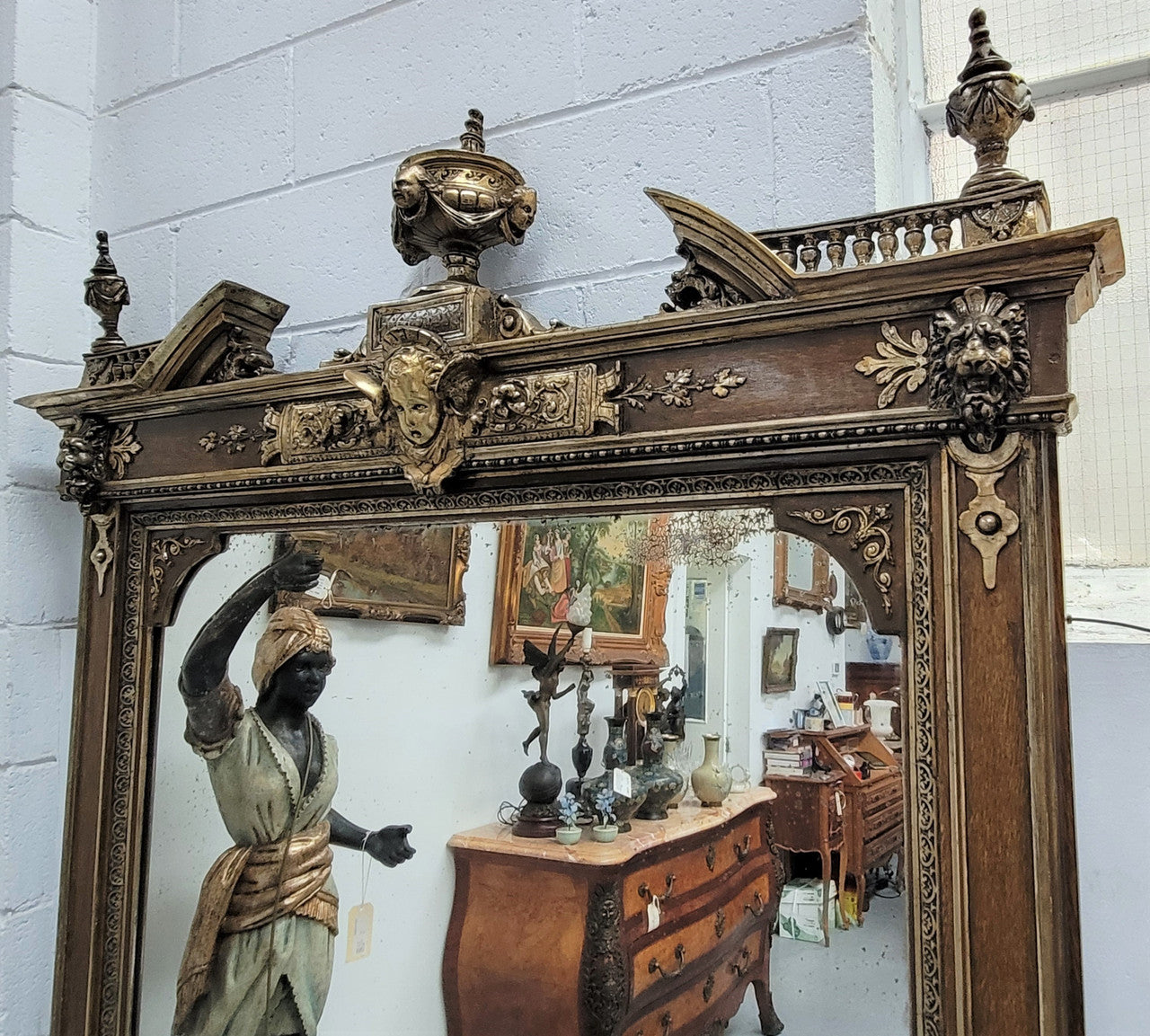 Early 19th Century French gilt and simulated wood mantel mirror. It still contains its original glass which contains loads of character. It is in very good detailed condition and has had minor restorations.