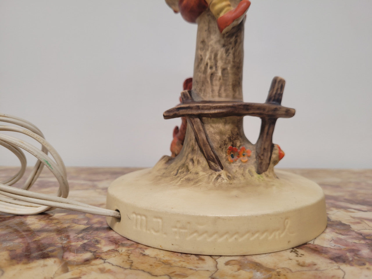 Charming Hummel Lamp featuring a young boy climbing an apple tree with a barking dog on the ground. Incised Hummel mark on side of base and 44A on base with 1935 (copyright) and Goebel W Germany. Height without shade 33.5cm