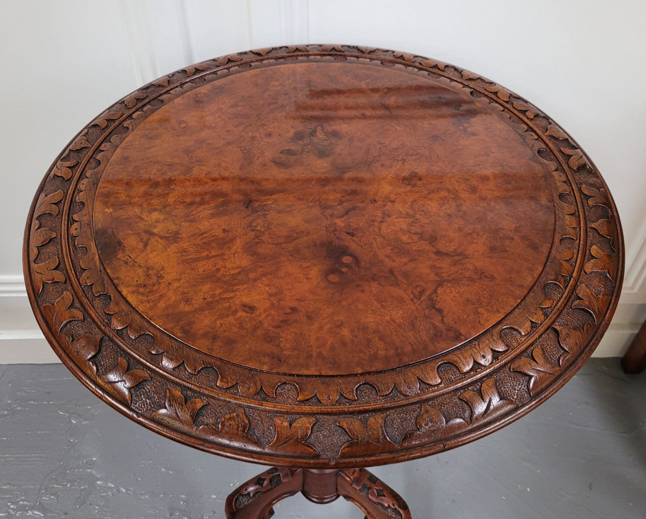 Rare early Victorian Irish Burr Walnut wine table. It has a beautiful carvings and a stunning burr walnut top, on a barley twist column and three shaped legs. It has been sourced locally and is in good original detailed condition. We also have a second table being sold separately which when together make a matched pair.