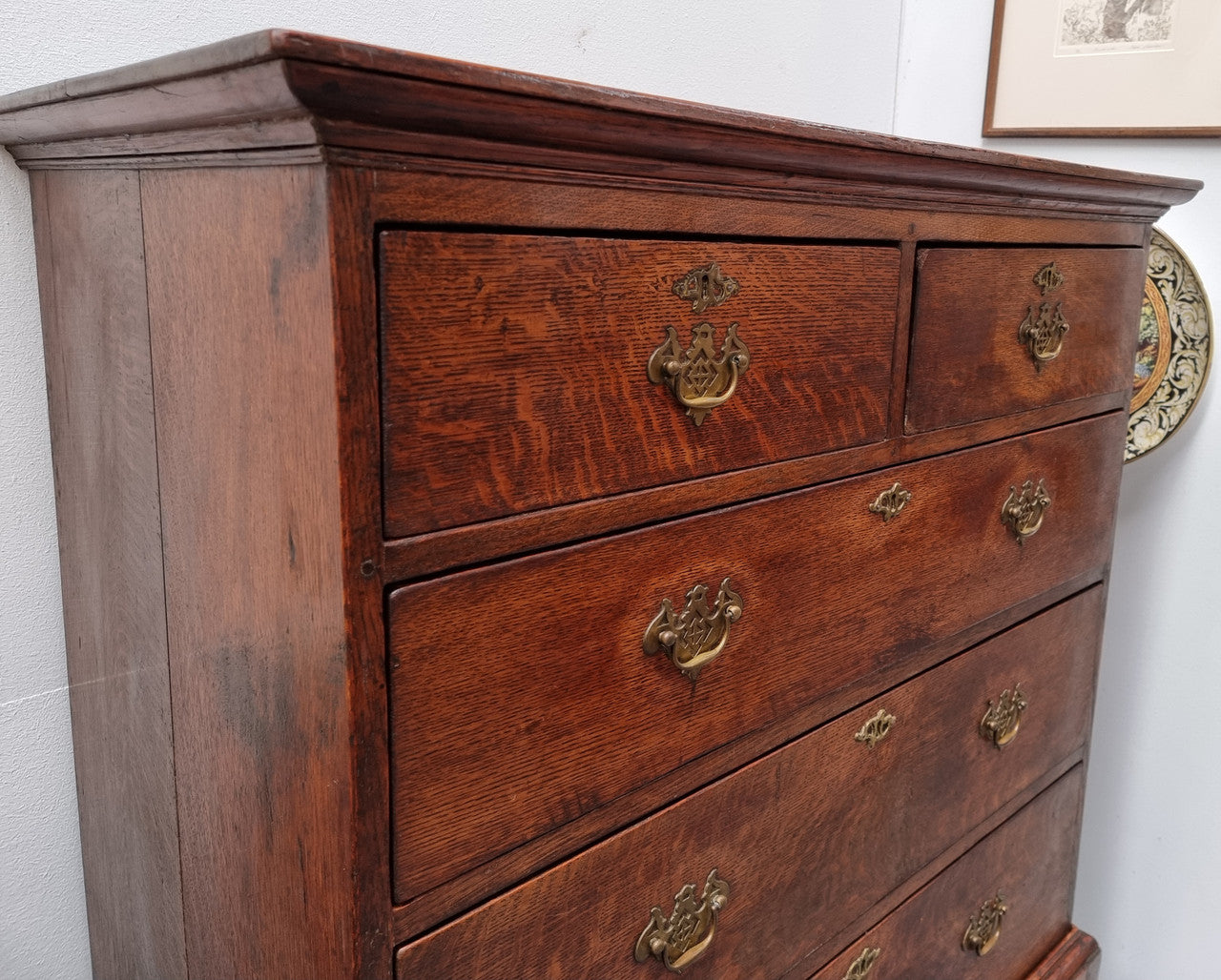 Early 19th Century English Oak chest on stand. It has been sourced in France and has plenty of storage space with eight drawers. In good original detailed condition.