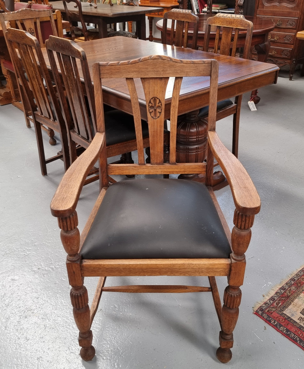 Tudor oak dining setting consisting of draw leaf extension table, 4 dining chairs and 2 carver chairs. Upholstery in excellent condition. Circa: 1930’s. The table, chair and carver chairs are in good original detailed condition.